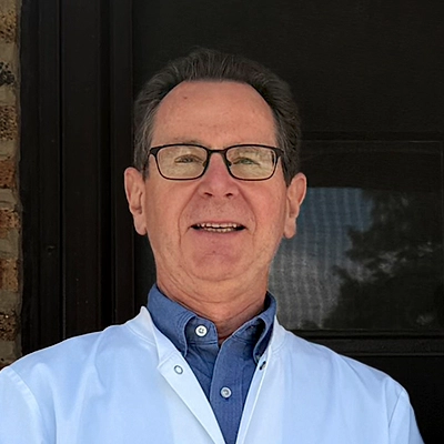 Dentist Daniel J. Fornatto Smiling In Lab Coat