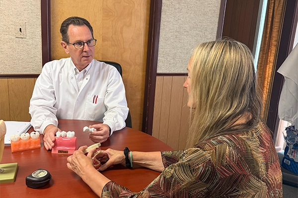 Daniel J. Fornatto Meeting With A Patient At A Desk