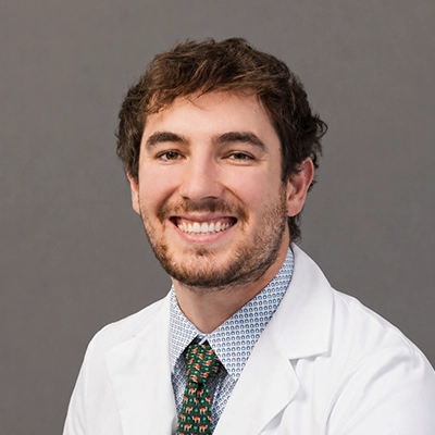 Dentist Nicholas Fornatto Smiling In Lab Coat